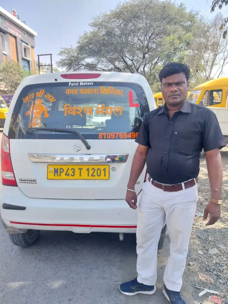 our-team-member-standing-next-to-a-white-maruti-wagon-r-driving-school-car |Vishwa Mangal Motor Driving School